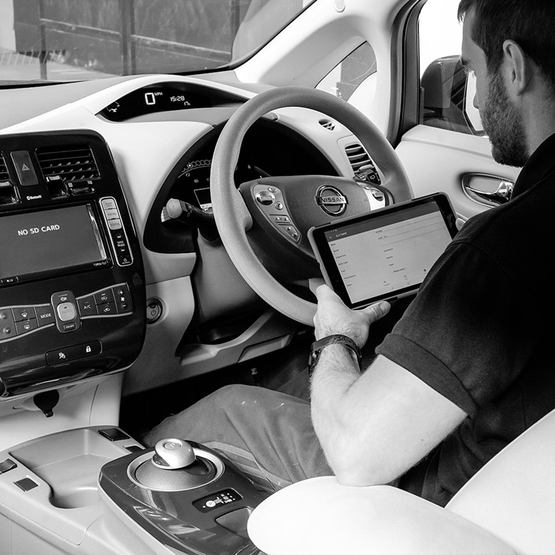 black and white shot of inspecting the interior of a Nissan